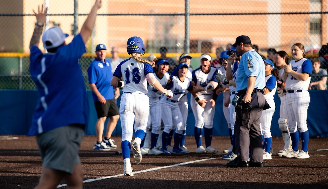 ACTION - Alexa Iwema is greeted by her teammates after hitting a home run