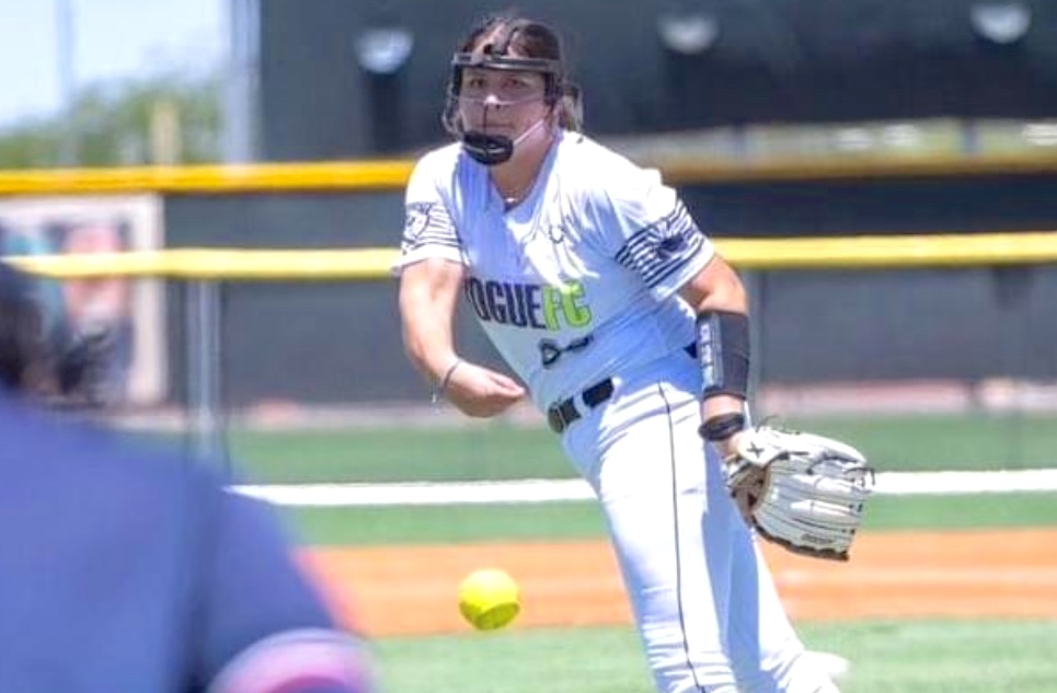 ACTION - Daniella Gloria watches her pitch sail in for a strike