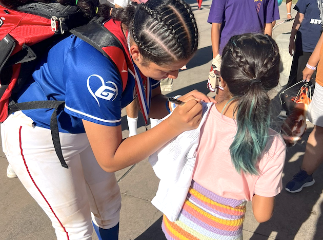 Karmen Vazquez signs an autograph for a young fan after her tremendous performance in the 2024 PGF Futures All-American Game on July 27, 2024