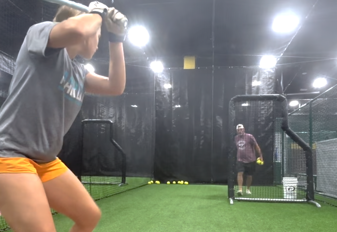 Tinley Goodson in the batting cages hitting off her father, Todd