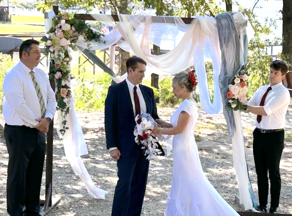 Shannon shares her wedding vows with Brentt while the officiant (left) and her son Dallas look on