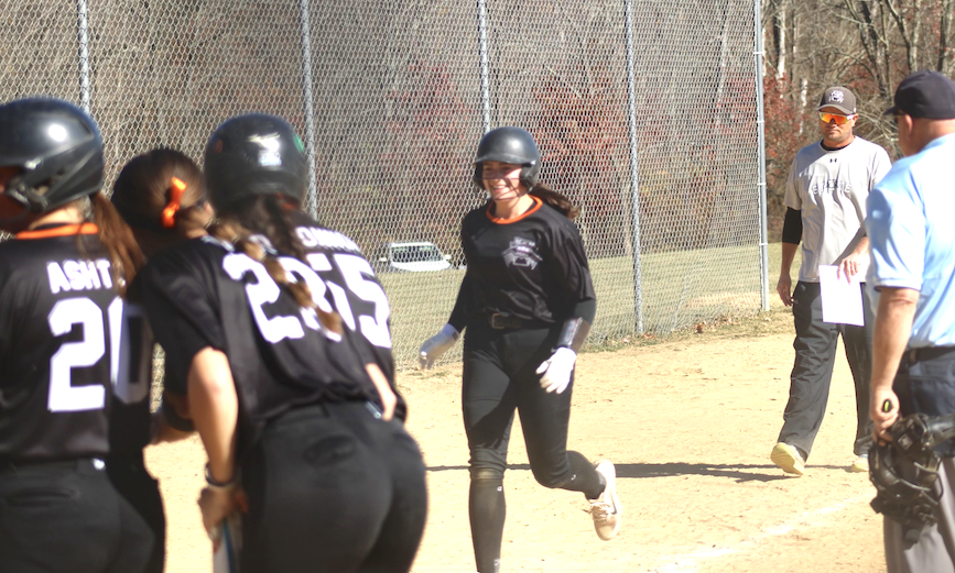 A common sight this fall - sophomore Rose Wendel crossing the plate after a home run