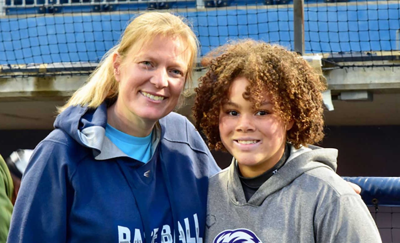 WPBL co-founder Justine Siegal with a young athlete. Photo - Sports Depiction via Baseball for All