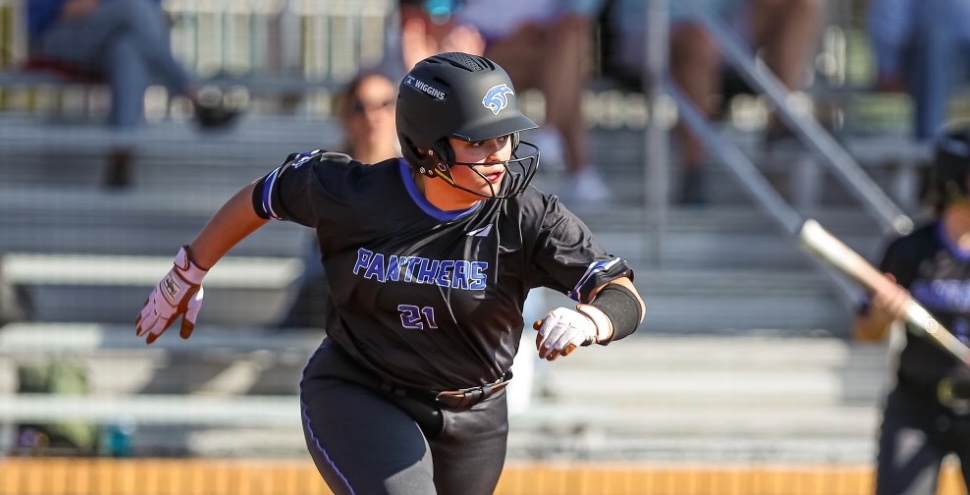 ACTION - Catcher Alexas Blaxckell of D1Vision watches her hit as she comes out of the box