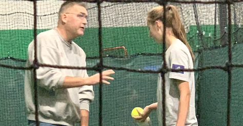 Teagan Kavan receiving instruction from Bill Hillhouse when she pitched for the Iowa Premier