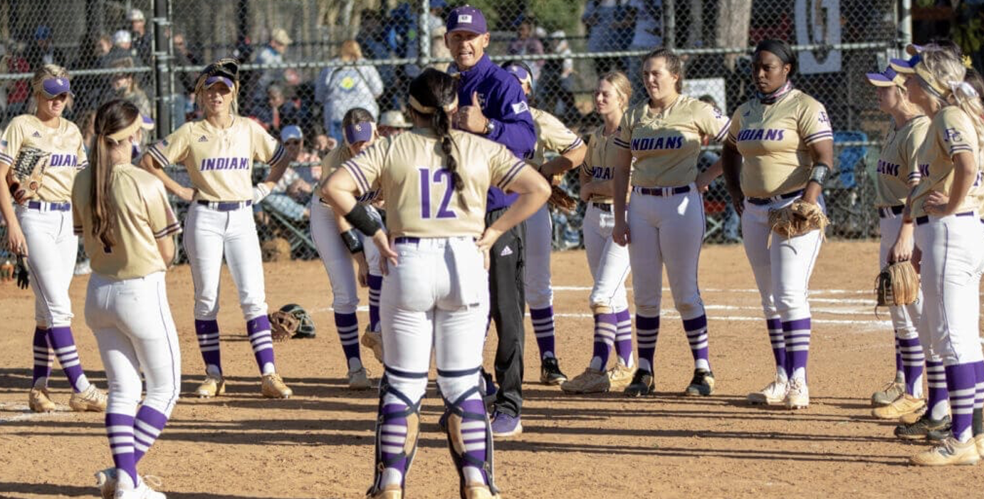 Coach Frankling Deloach speaks to his East Coweta High softball team