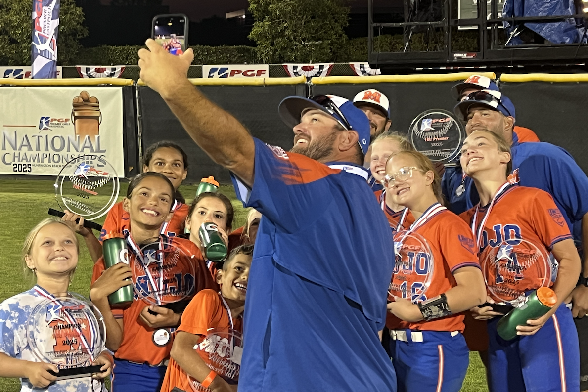 Head Coach Roger Edwards takes a selfie with his team after the title game, a 11-0 victory
