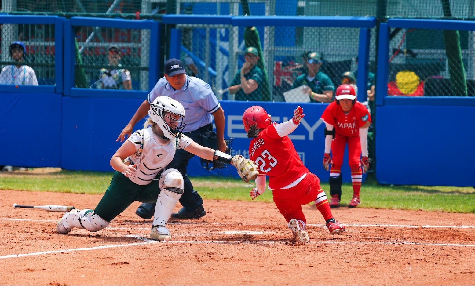 Urara Fujimoto of Japan slides to score in her team's 10-3 over Australia