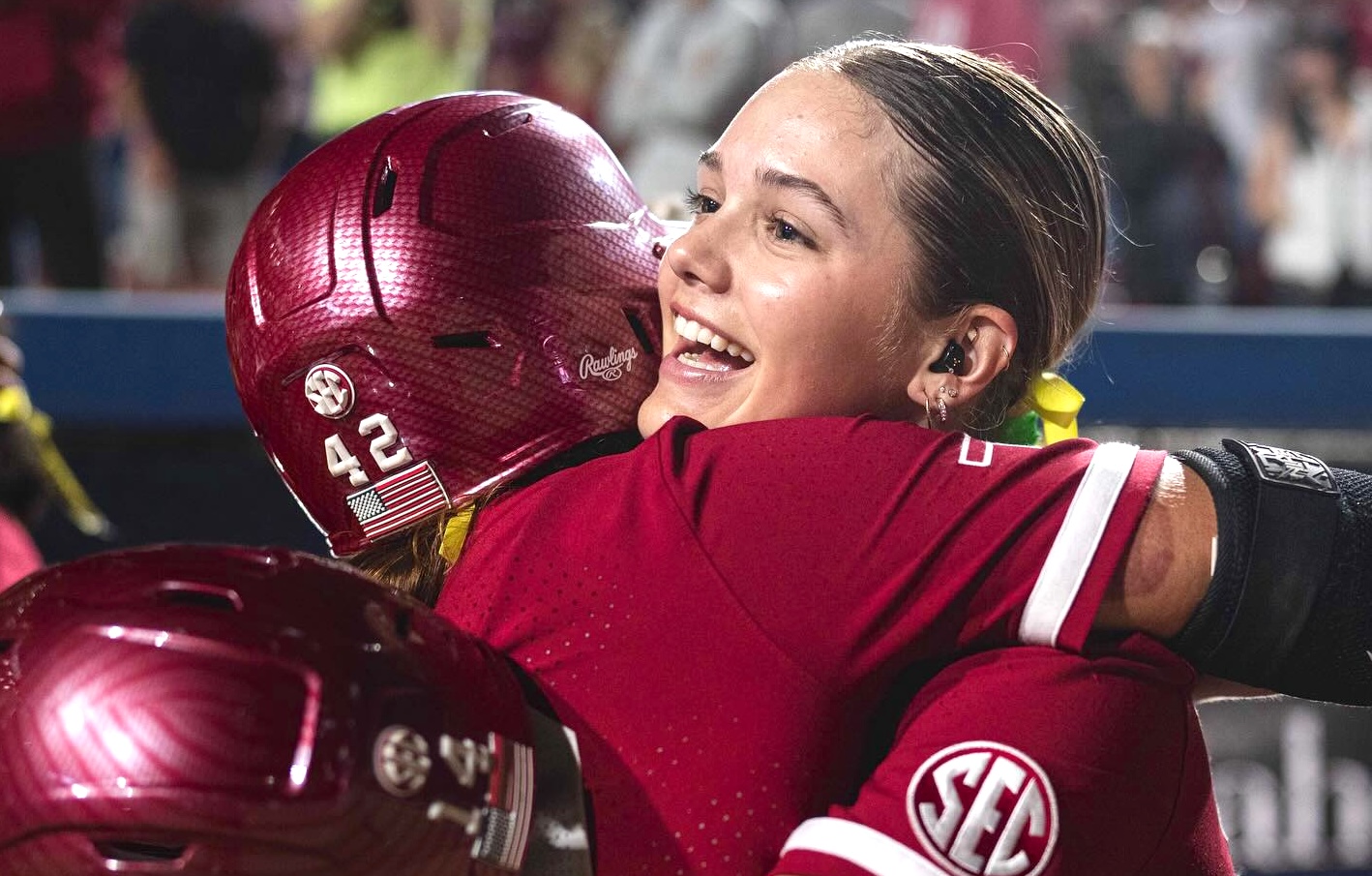 Riley (right) hugs teammate Gabby Garcia on the field after a big play