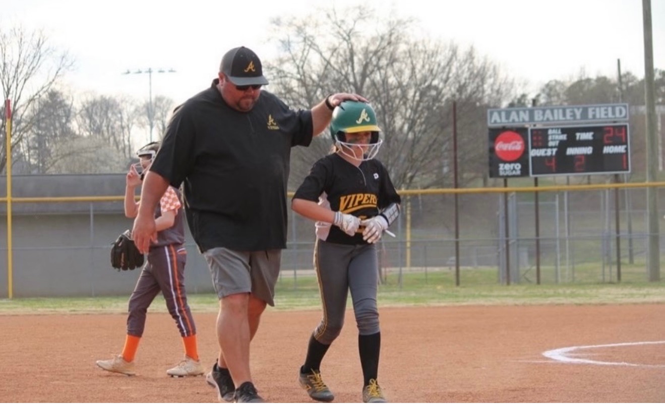 Coach Lynch working with a young player.