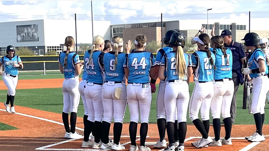 The Wisconsin Lightning 18U players welcome Claire Giese after her home run in Saturday pool game action