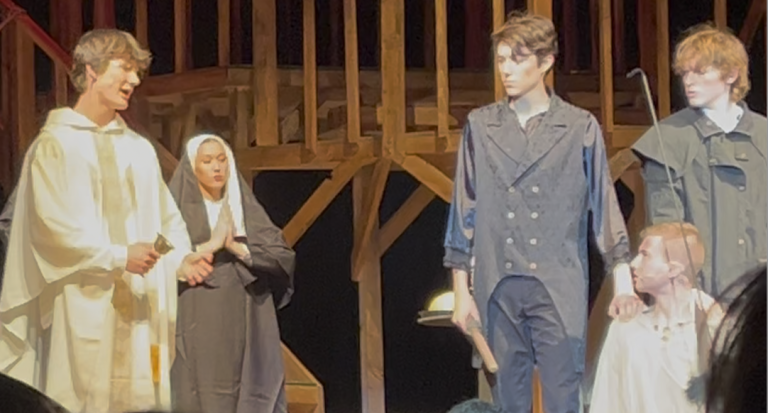 Ashton Eads (left) singing as the priest in Les Miserables performed Wednesday, February 25, 2026