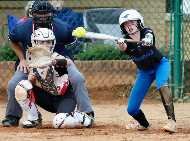 ACTION - Annie Cox, an outfielder for the Birmingham Mustangs 2030 team, reaches out to make the bunt