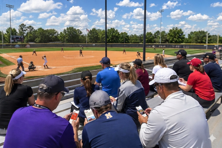 A scene shot at a game where college coaches in the stands are using the Talent Tracker to follow players they're iterested in