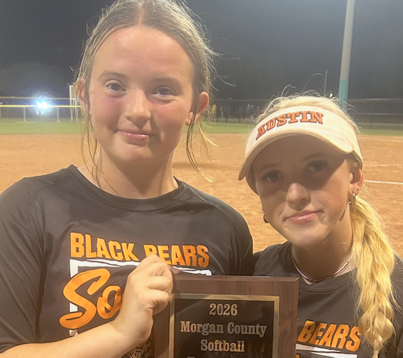 Grace and Evelyn Lamb hold the plaque they won for capturing the county title earlier in April 2026