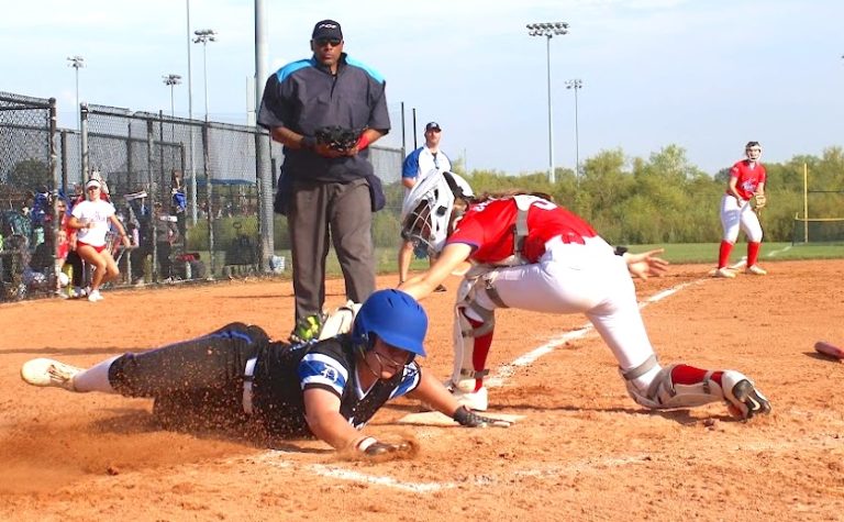 ACTION - 77 - Madeline Pochos of the Lady Dukes Chicago 2029 team beats the tag at home plate.