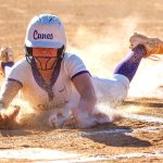 ACTION - Sam Porter of Georgia Impact Premier - McBay 16U and Cartersville (Ga.) High slides safely across the plate while getting a faceful of dirt