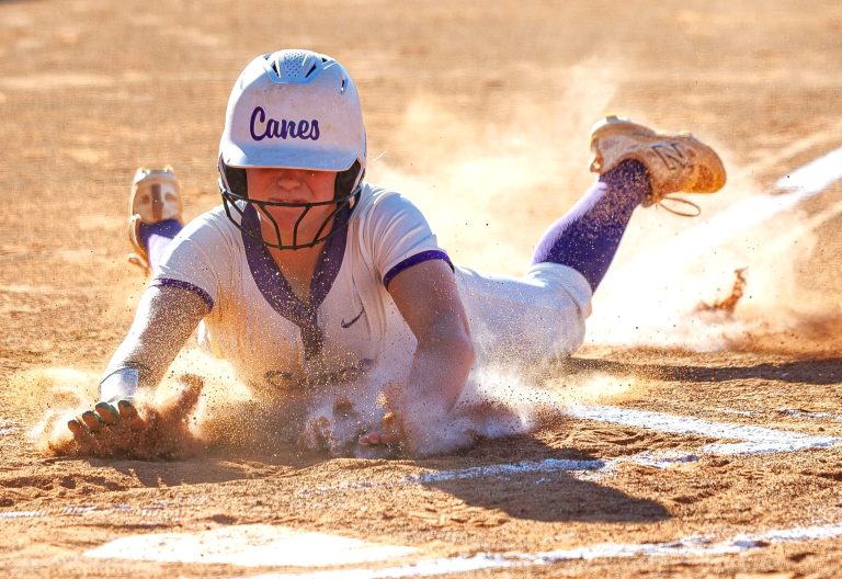 ACTION - Sam Porter of Georgia Impact Premier - McBay 16U and Cartersville (Ga.) High slides safely across the plate while getting a faceful of dirt