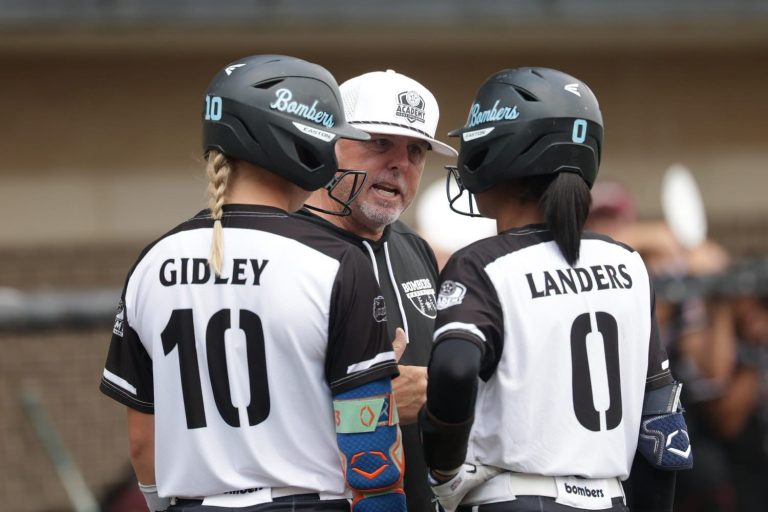 Coach Smith talking to two of his elite sophomores, shortstop Michaela Landers and second baseman Brooklyn Gidley