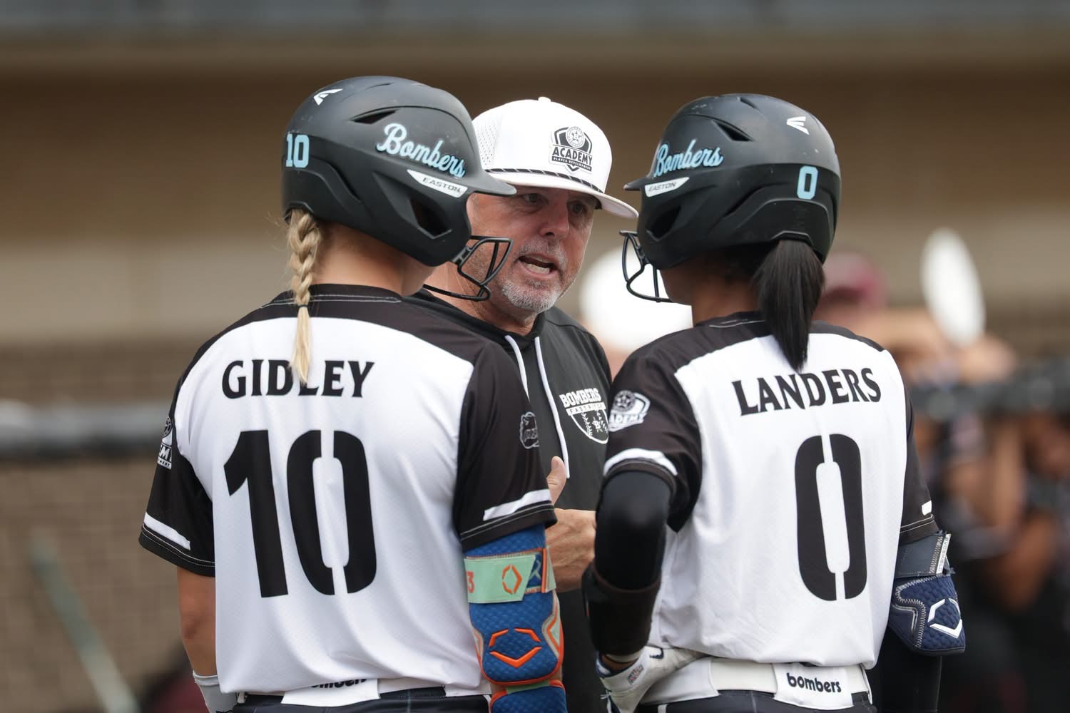 Coach Smith talking to two of his elite sophomores, shortstop Michaela Landers and second baseman Brooklyn Gidley