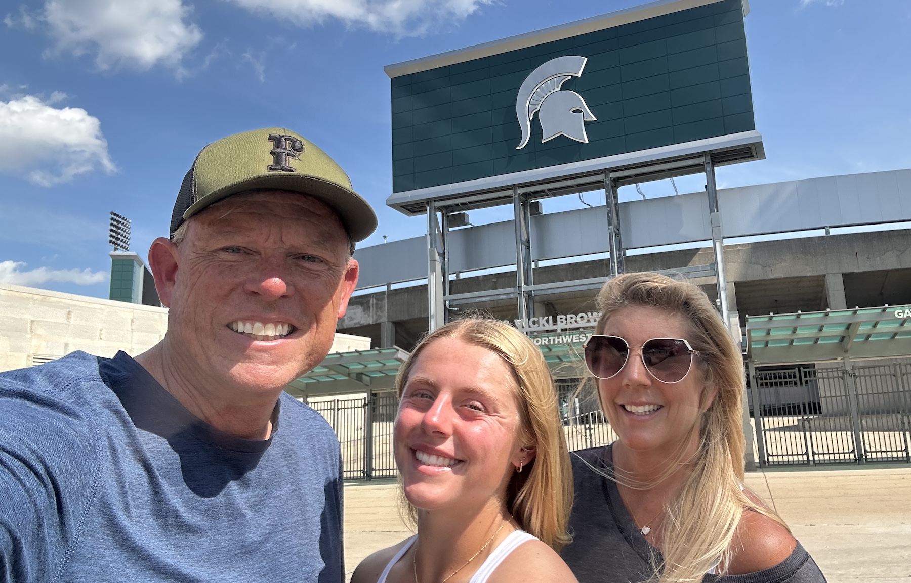 Teal Hamman and her parents at Michigan State's Secchia Stadium
