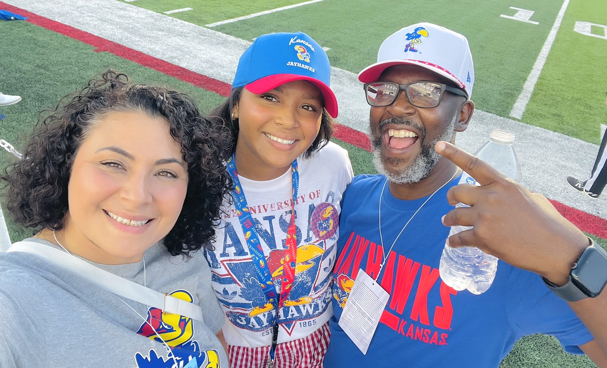 Amiyah Currie shares a moment with her parents while embracing her future as a Kansas Jayhawk